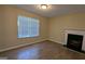 Bright living room with wood floors, a large window, and a cozy fireplace at 5300 Forest Downs Ln, Atlanta, GA 30349