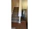 Carpeted stairs with white banister leading from hardwood floor and a lower level at 5300 Forest Downs Ln, Atlanta, GA 30349