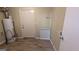 Utility room with vinyl floors, water heater and access door at 5300 Forest Downs Ln, Atlanta, GA 30349