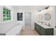 Modern bathroom featuring a soaking tub, double vanity, and stylish fixtures at 1928 Wildwood Dr, Decatur, GA 30032