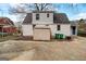 Backyard view featuring a shed, painted brick, greenery, and a paved area for parking at 2013 Marco Dr, Decatur, GA 30032