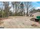 Spacious backyard with a paved parking area, storage shed, and mature trees at 2013 Marco Dr, Decatur, GA 30032