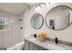 Modern bathroom with double vanity, granite countertops, and a tiled shower with glass door at 2013 Marco Dr, Decatur, GA 30032