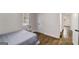 A cozy bedroom with hardwood floors, a decorative wall display, and natural light from the window at 2013 Marco Dr, Decatur, GA 30032