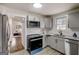 Modern kitchen featuring updated appliances, granite countertops, and seamless flow to the living room at 2013 Marco Dr, Decatur, GA 30032