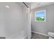 Modern bathroom featuring white subway tiles, a shower and a window at 2955 Peeksville Rd, Locust Grove, GA 30248