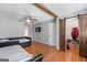 Bedroom with wood floors, daybeds, sliding barn door, and ceiling fan at 2955 Peeksville Rd, Locust Grove, GA 30248