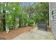 Backyard and patio with gray siding against lush greenery at 4001 Avalon Sw Rd, Atlanta, GA 30331