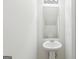 Half bathroom with a pedestal sink and modern lighting fixture above the mirror at 4001 Avalon Sw Rd, Atlanta, GA 30331