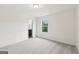 Inviting bedroom with neutral carpet, a window, and an open closet at 4001 Avalon Sw Rd, Atlanta, GA 30331