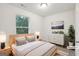 Staged bedroom featuring a comfortable bed, dresser, and view from a sunny window at 4001 Avalon Sw Rd, Atlanta, GA 30331