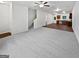 Expansive living room with plush carpeting, ceiling fan, and view of the staircase and eat-in kitchen at 4001 Avalon Sw Rd, Atlanta, GA 30331