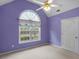 Purple bedroom with vaulted ceiling, ceiling fan and window at 716 Euel Dr, Mcdonough, GA 30252