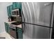 Close-up of kitchen showcasing stainless steel appliances, dark cabinetry, and mosaic backsplash at 2700 Pine Ne St # 2108, Atlanta, GA 30324