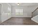 Spacious living room with hardwood floors and neutral color palette at 767 Hennepin Ter, Mcdonough, GA 30253