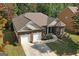 Aerial view of a brick home with a well-maintained lawn and a two-car garage at 4424 Bellwood Cir, Atlanta, GA 30349