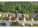 Aerial view of an estate with a tree-lined street and houses with brown roofs at 4424 Bellwood Cir, Atlanta, GA 30349