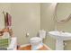 Charming powder room with pedestal sink, round mirror, and neutral tones at 4424 Bellwood Cir, Atlanta, GA 30349