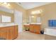 Bathroom with double sinks, a soaking tub with tile surround, and lots of storage at 4424 Bellwood Cir, Atlanta, GA 30349