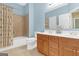 Bathroom featuring a shower and tub combination with double sinks at 4424 Bellwood Cir, Atlanta, GA 30349