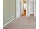 The bedroom leads to a bathroom and features a large closet and plush carpet at 4424 Bellwood Cir, Atlanta, GA 30349