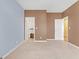 Spacious bedroom with neutral carpet, multiple closets, and an open doorway at 4424 Bellwood Cir, Atlanta, GA 30349