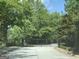Gated entrance surrounded by lush trees, providing privacy and security for the property at 4424 Bellwood Cir, Atlanta, GA 30349
