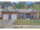 Charming brick home featuring a two-car garage, manicured lawn, and inviting entrance with well-maintained landscaping at 4424 Bellwood Cir, Atlanta, GA 30349