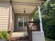 Inviting front porch with classic lantern, white columns, and brown trim detail at 4424 Bellwood Cir, Atlanta, GA 30349