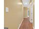 Hallway with hardwood flooring and tan walls at 4424 Bellwood Cir, Atlanta, GA 30349