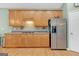 Bright kitchen with stainless steel appliances, wooden cabinets and hardwood floors at 4424 Bellwood Cir, Atlanta, GA 30349