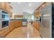 Open kitchen featuring wood cabinets, stainless appliances, and hardwood flooring at 4424 Bellwood Cir, Atlanta, GA 30349