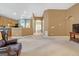Spacious living area featuring neutral carpet and seamless flow into the kitchen at 4424 Bellwood Cir, Atlanta, GA 30349