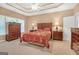Spacious main bedroom with tray ceiling, wood furniture, and cozy bedding at 4424 Bellwood Cir, Atlanta, GA 30349