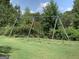 Outdoor playground with swings surrounded by green grass and trees at 4424 Bellwood Cir, Atlanta, GA 30349