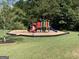 Colorful playground with slides and climbing structures, set in a grassy area at 4424 Bellwood Cir, Atlanta, GA 30349