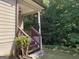 An inviting side porch features a wooden railing and columns at 4424 Bellwood Cir, Atlanta, GA 30349
