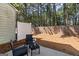 Cozy backyard patio with wicker furniture, privacy fence, and wooded backdrop at 2783 Parkway Cv, Lithonia, GA 30058