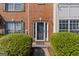 Charming brick facade with a welcoming front door, complemented by manicured shrubbery at 2783 Parkway Cv, Lithonia, GA 30058