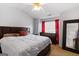 Spacious main bedroom featuring a ceiling fan, plush bed, and natural light at 2783 Parkway Cv, Lithonia, GA 30058
