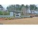 The Canoe Club community entrance with stonework and landscaping at 140 Dockside Dr # 381, Fayetteville, GA 30215