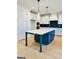 Kitchen with a large island, white cabinets, and dark green lower cabinets at 140 Dockside Dr # 381, Fayetteville, GA 30215