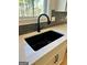 Kitchen with a black farmhouse sink and modern faucet at 140 Dockside Dr # 381, Fayetteville, GA 30215