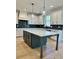 Kitchen with a large island, white cabinets, and dark green lower cabinets at 140 Dockside Dr # 381, Fayetteville, GA 30215