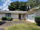 A single-story white brick home with an attached garage and a front yard at 2071 Twin Falls Rd, Decatur, GA 30032