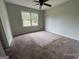 This bedroom features neutral walls, carpeted floors, and a window letting in natural light at 2177 E Chester Cir, Conyers, GA 30013