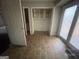 Tiled bonus room with natural light, built in shelving and an open door at 2177 E Chester Cir, Conyers, GA 30013