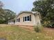 A side view of the home with large windows and a well-maintained brick foundation at 2177 E Chester Cir, Conyers, GA 30013