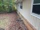 Side of house view featuring vinyl siding, brick foundation and gutter system at 2177 E Chester Cir, Conyers, GA 30013