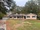 Charming single-story home with a spacious front yard and attached garage at 2177 E Chester Cir, Conyers, GA 30013